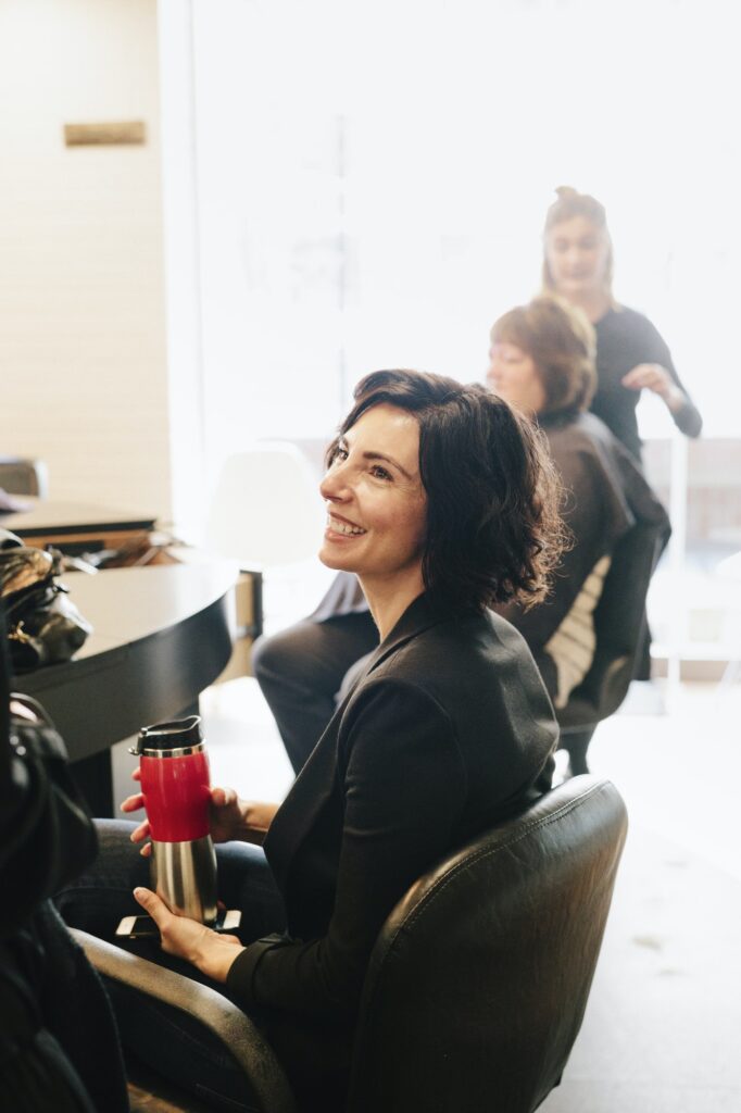 A client sitting in a hair salon chair.