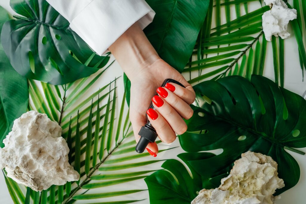 Manicured woman's nails with red nail polish.